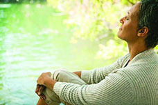 picture of elderly woman in state of bliss by lake