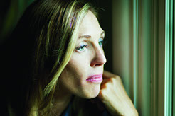 picture of depressed woman staring out of window